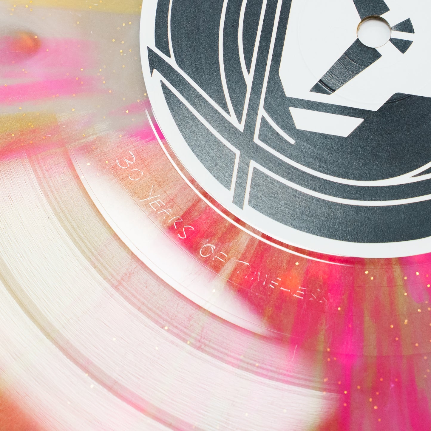 Close-up of a Goldie vinyl record with colorful swirls and '30 Years of Timeless' text.